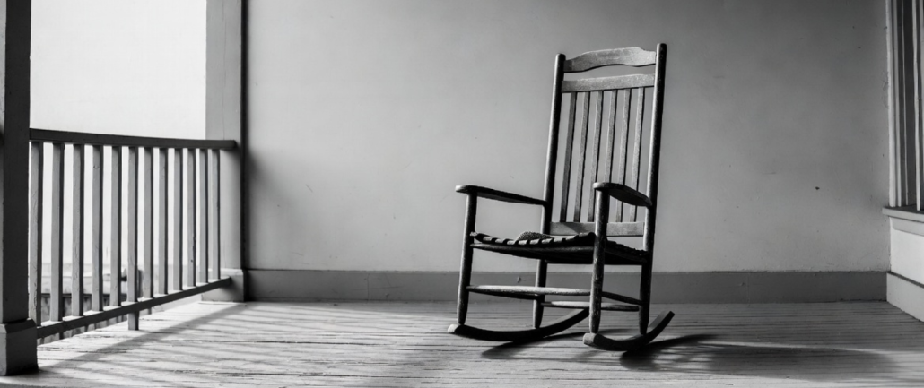 A lone rocking chair on a porch